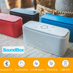 SoundBox Bluetooth speakers in various colors on a wooden floor.